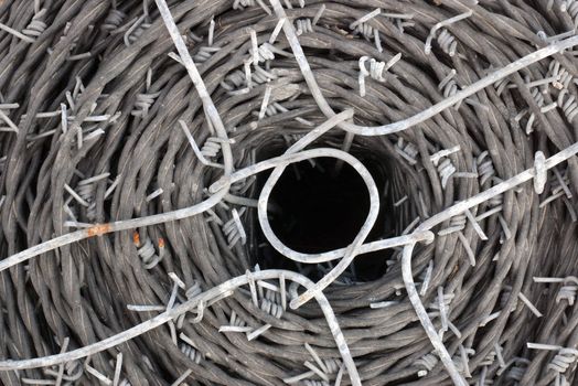 spool of barbed wire used for buillding fences and construction