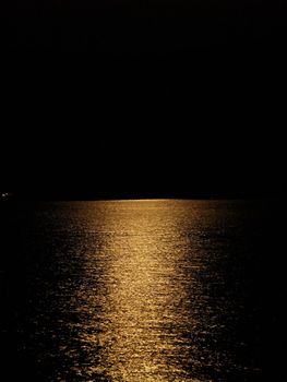 Moon light reflection on calm but rippled water