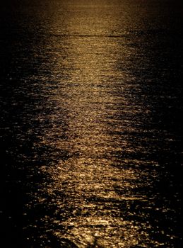 Moon light reflection on calm but rippled water