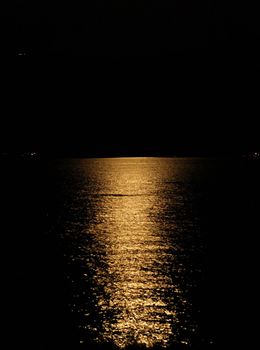 Moon light reflection on calm but rippled water