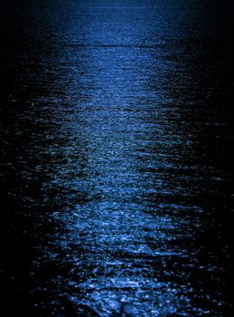 Moon light reflection on calm but rippled water