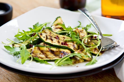 Grilled courgette with dreid chilli flake ,rocket and mint salad