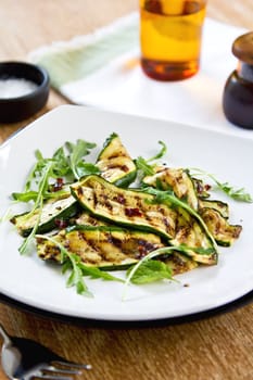 Grilled courgette with dreid chilli flake ,rocket and mint salad