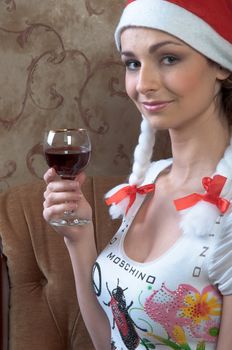Young and beautiful girl with gifts waiting for the Christmas and New Year