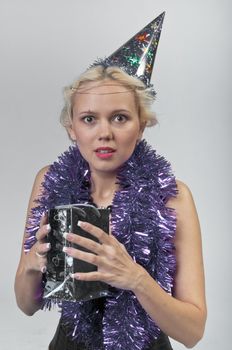 Young and beautiful girl with gifts waiting for the Christmas and New Year