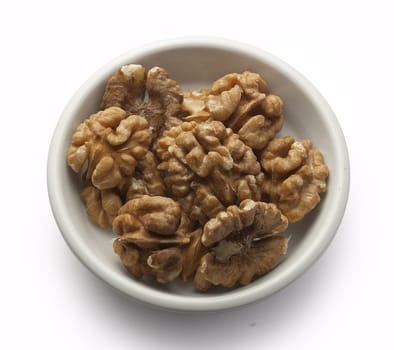 Handful of walnut on the white plate