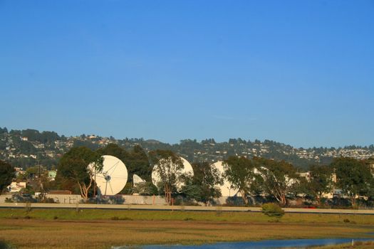 Big satellite dishes in a park.
