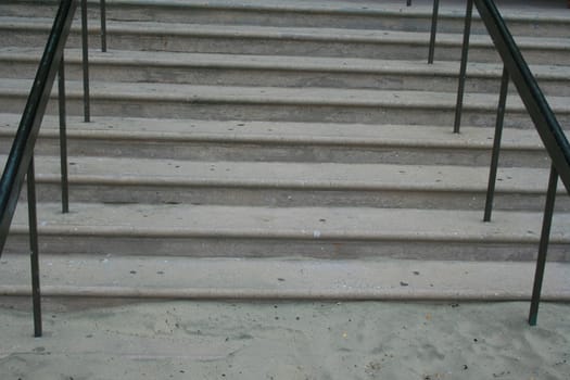 Close up of steps and handrails of an entrance.
