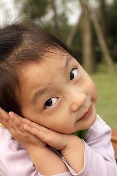 4 year old Chinese girl pretending to be model in a Beijing Park