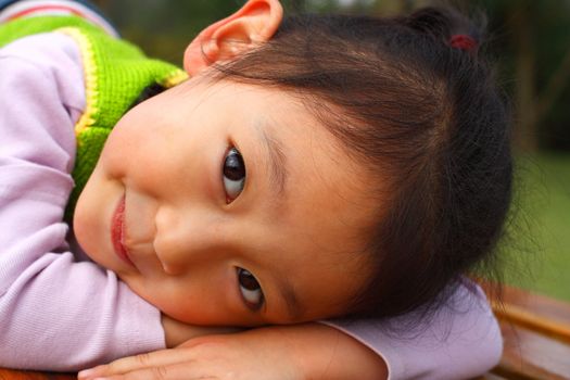 4 year old Chinese girl pretending to be model in a Beijing Park