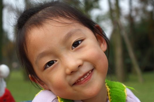 4 year old Chinese girl pretending to be model in a Beijing Park