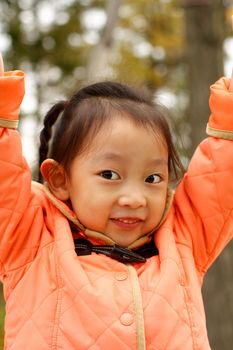 4 year old Chinese girl pretending to be model in a Beijing Park