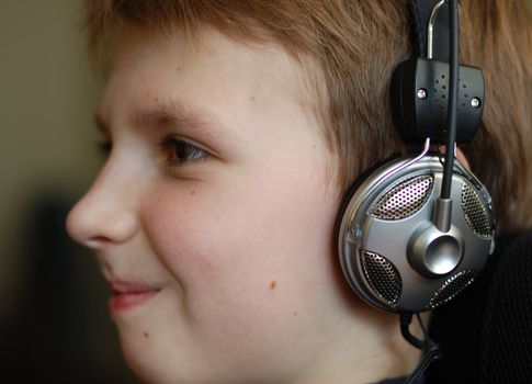 Boy listen to music by headphones.