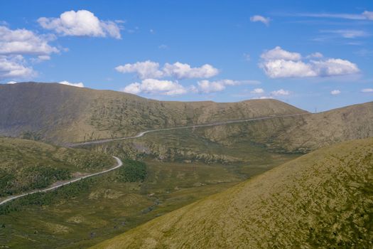 valley with road and cloudly sky
