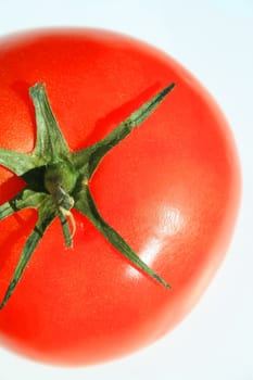 Close up of a red tomato on a white background.
