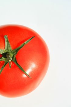 Close up of a red tomato on a white background.
