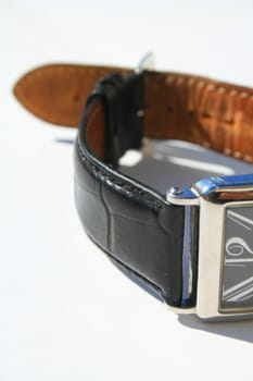 Close up of a wristwatch on a white background.
