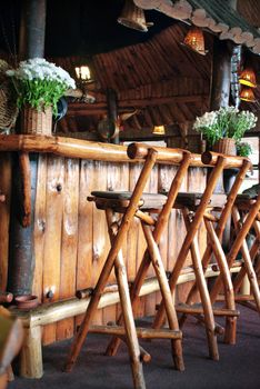 wooden bar and chairs in small restaurant