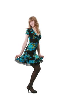 The long-legged woman poses in a beautiful dress