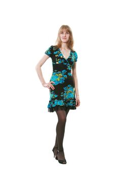 The long-legged woman poses in a beautiful dress