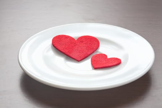 Red hearts on a plate. Valentine's Day