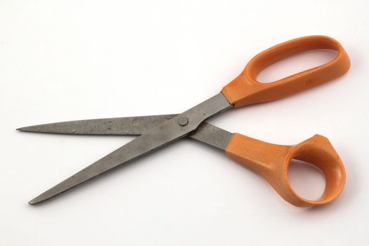 Orange scissors on a white background.