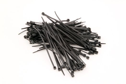 Black nylock cable ties on a white background.