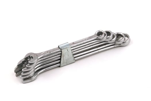 Set of chrome spanners on a white background.