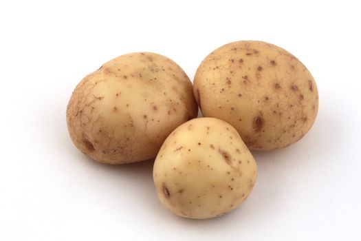 Close up of potatoes on a white background.