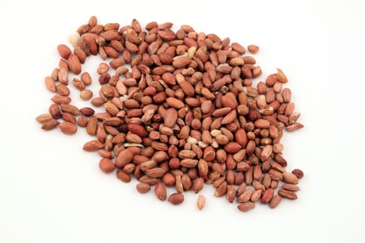 Roasted peanuts or groundnuts on a white background.