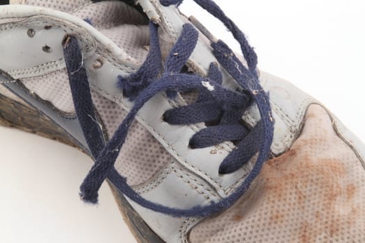 Old training shoe on a white background.