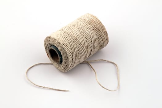 Ball of string or twine on a plain white background