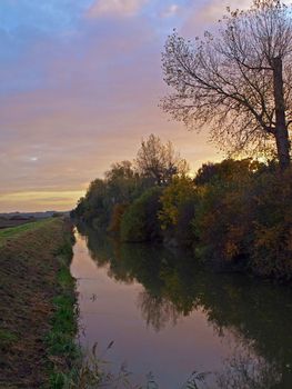 Photo taken on an autumn day at sunset from the bridge over Great Raveley Drain, at the entrance to Woodwalton fen.