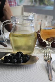 Mediterranean white wine and black olives 