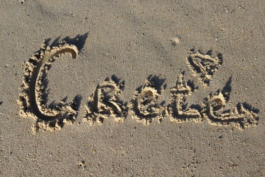 Inscription Crete on the wet sand