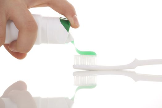 Tooth brush with tooth paste on white background