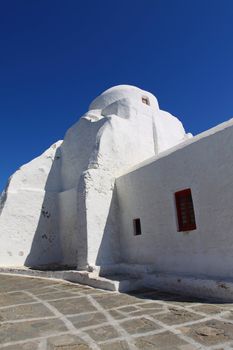 Old Paraportiani 14 century church in the clouds - the most famous and popular place on the island Mikoneos in Greece 