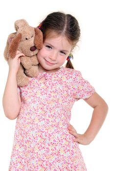 Little girl with a soft toy on the white background
