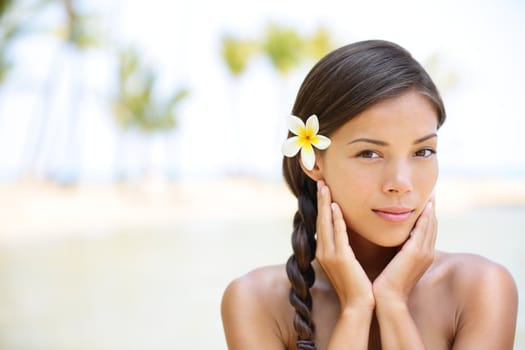 Wellness beauty portrait. Serene multicultural woman outdoors at tropical luxury spa resort. Young mixed race Asian Caucasian female model on Hawaii.