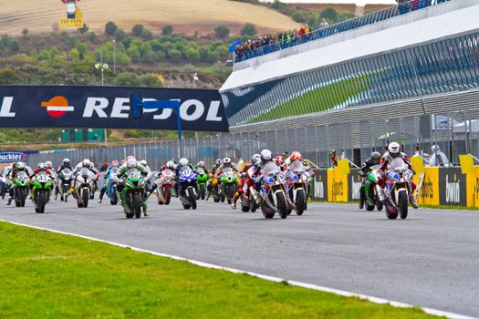 JEREZ DE LA FRONTERA, SPAIN - NOV 20: Motorbike competitors begin the Stock Extreme race in the CEV Championship  on November 20, 2011 in Jerez de la Frontera, Spain