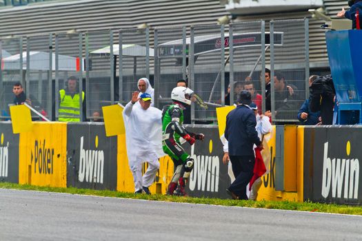 JEREZ DE LA FRONTERA, SPAIN-NOV 20: Stock Extreme motorcyclist Antonio Alarcos try to leave the track after an accident in the CEV Championship race on November 20, 2011 in Jerez de la Frontera, Spain