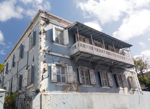 Old delapidated house in the old town of Charlotte Amalie St Thomas USVI with ornate balcony