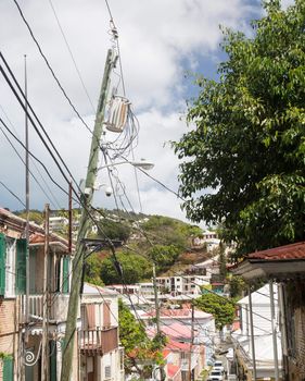 Complicated wiring forms tangled mess on power pole with light and camera in Charlotte Amalie St Thomas
