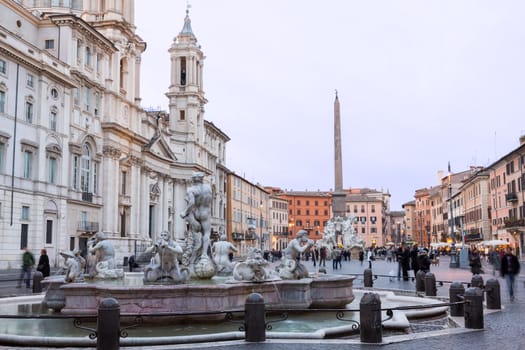 ROME, ITALY - JANUARY 29: Tourists and locals stroll in Piazza Navona in Rome on January 29, 2013. The famous statue was built in 1651