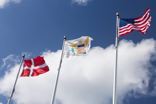 Flags of USA, US Virgin Islands and Denmark fly outside Government House in St Thomas