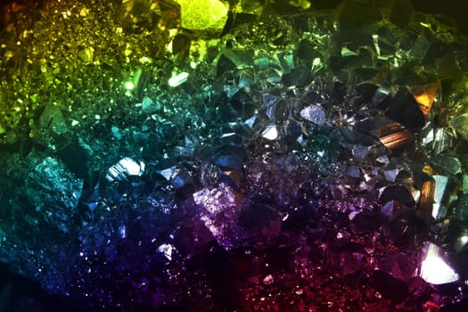 A background of a precious crystal background lit in different colors.