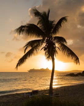 Cruise ship leaves Charlotte Amalie at sunset past Frenchmans bay on St Thomas USVI