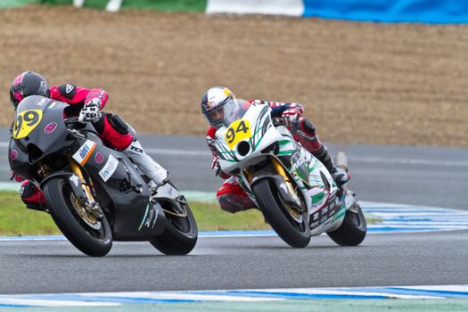 JEREZ DE LA FRONTERA, SPAIN - NOV 19: Moto2 motorcyclist Mahias (99) and Folger(94) take a curve in the CEV Championship race on November 19, 2011 in Jerez de la Frontera, Spain.