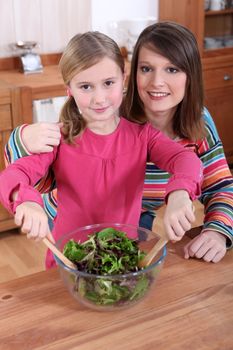 Mother and daughter making a salad together