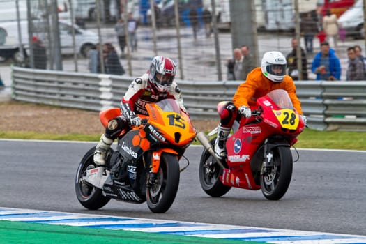 JEREZ DE LA FRONTERA, SPAIN - NOV 20: Moto2 motorcyclist Tirado (15) and Tortosa (28) race in the CEV Championship race on November 20, 2011 in Jerez de la Frontera, Spain.